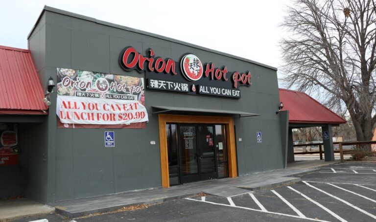 Gray storefront with large glass doors and Orion Hot Pot All You Can Eat sign